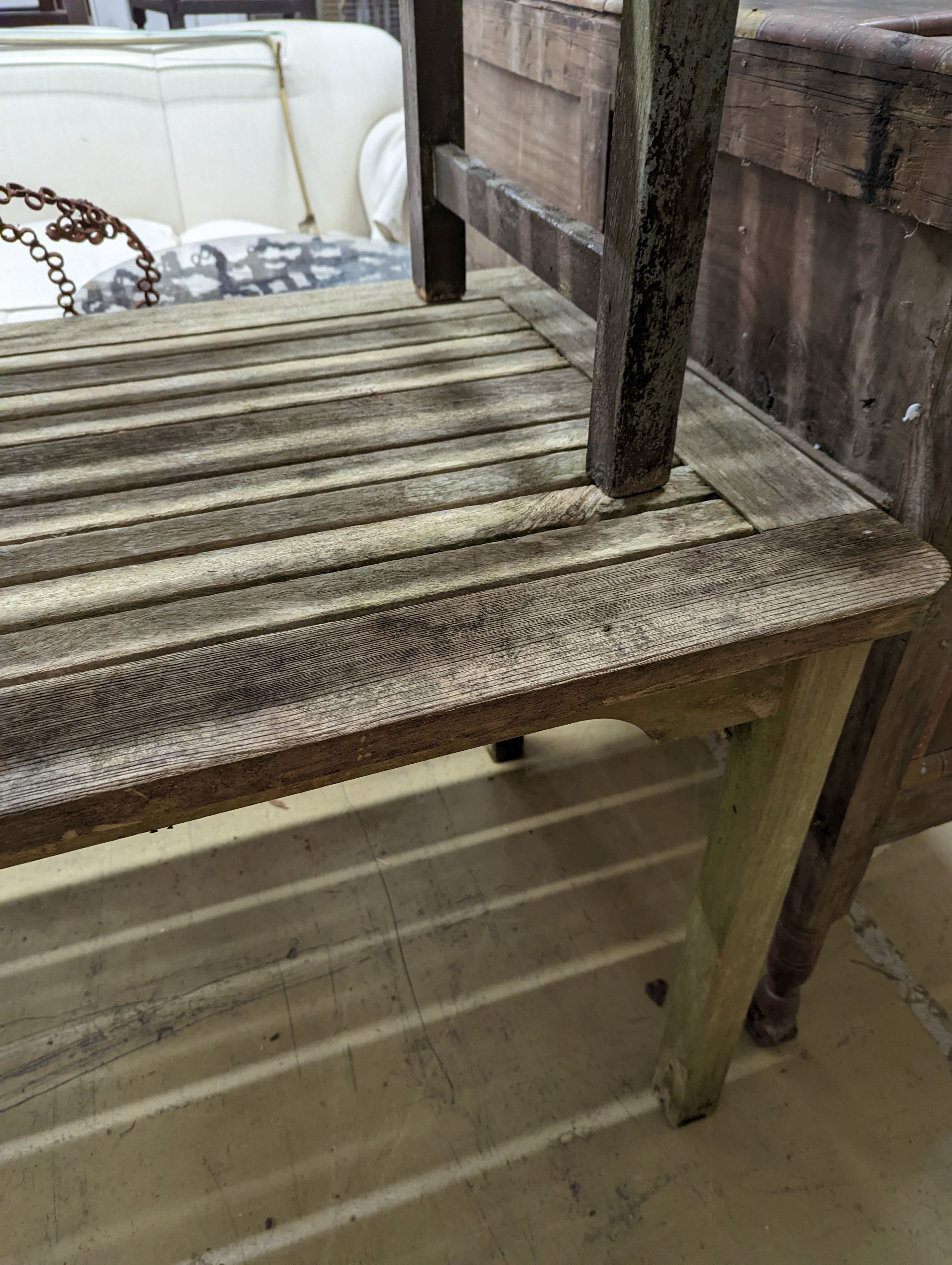 A weathered teak garden bench and rectangular table. Bench - W-122cm, D-54cm, H-83cm. Table - W-149cm, D-70cm, H-74cm.